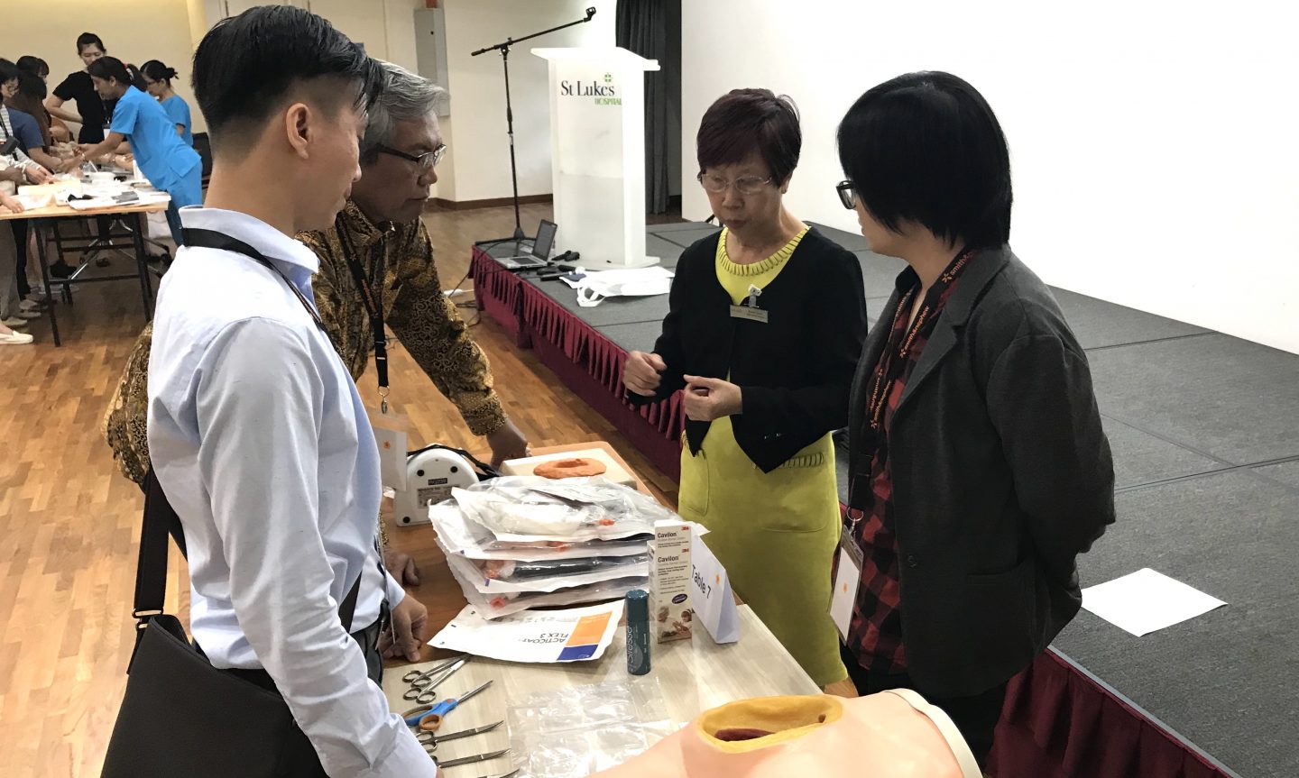 Susie Goh (second from right) trains other healthcare professionals on how to treat wounds effectively at the Negative Pressure Wound Therapy course. St Luke's