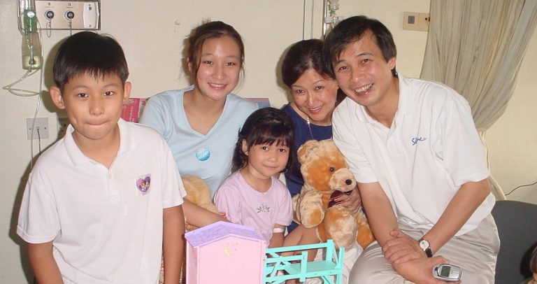 Photo of the Lyn family taken in 2002, on Sarah's fourth birthday. From left to right: Andrew, Frances, Sarah, Nancy and Ps Philip.