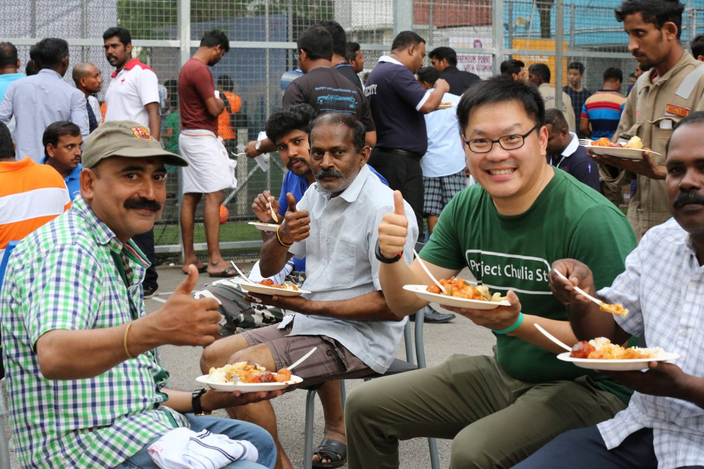 Shaun Lee (second from right), managing director of Project Chulia Street, sharing a meal with migrant workers at the recent fiesta at Westlite Woodlands Dormitory. Photo courtesy of Project Chulia Street.