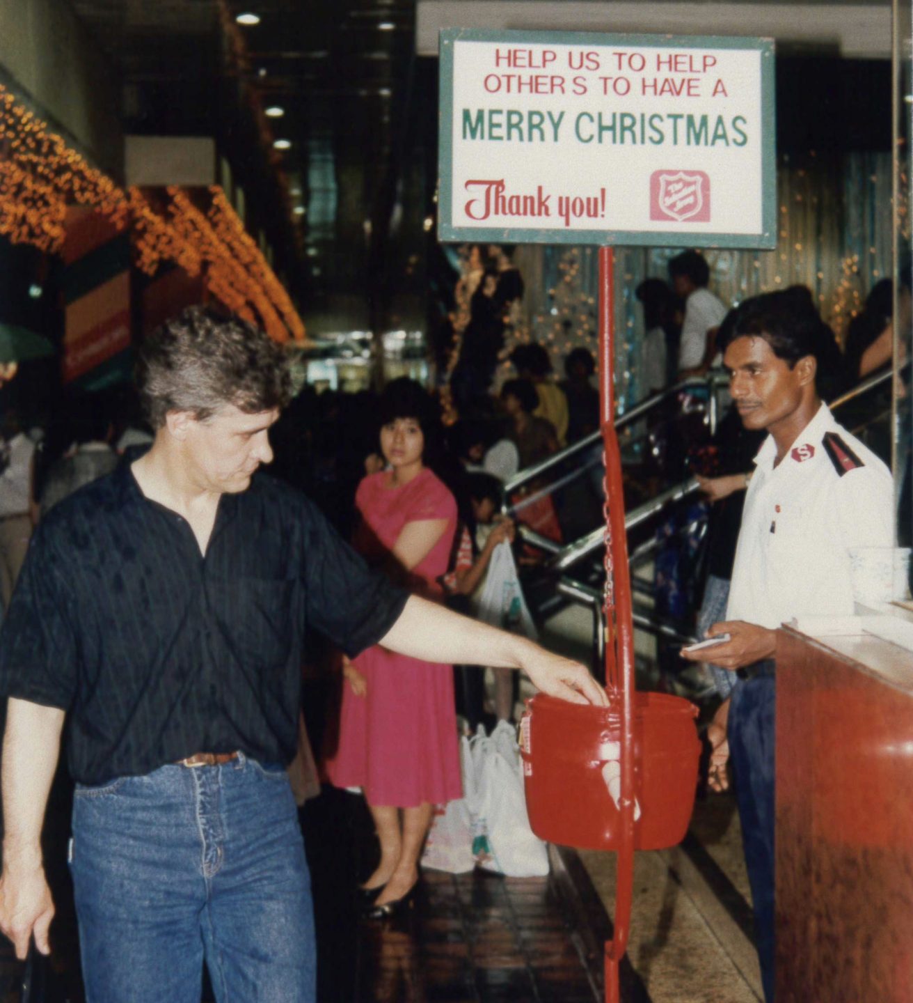 In his years manning the Christmas Kettles, P. Kunam (right) has had the chance to cross paths with many, who have been blessed by the Salvation Army's work with the community, returning to donate and bless others. Photo courtesy of the Salvation Army Singapore.