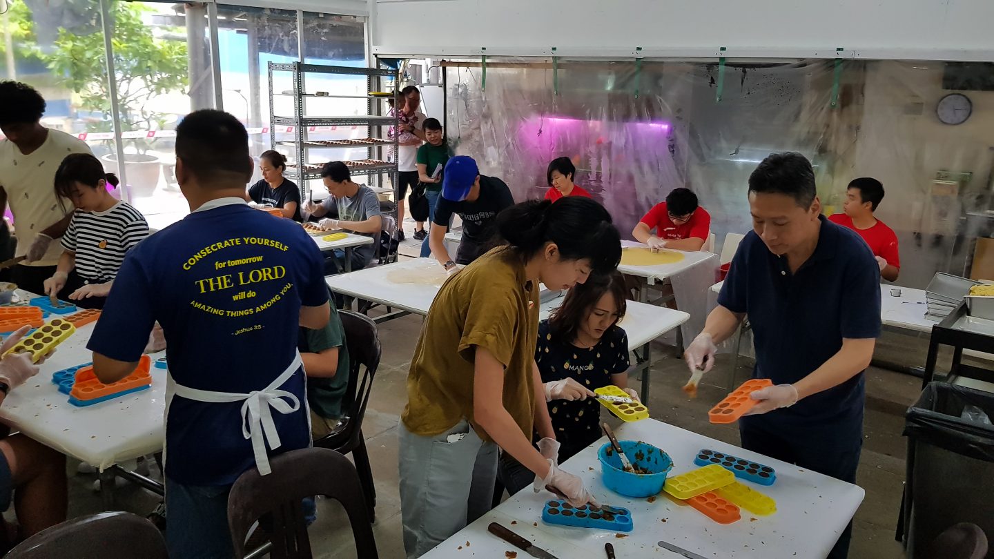 Residents and volunteers helping to bake pineapple tarts. Everything from pastry to jam is handmade. Photo by Yeo Kai Wen.