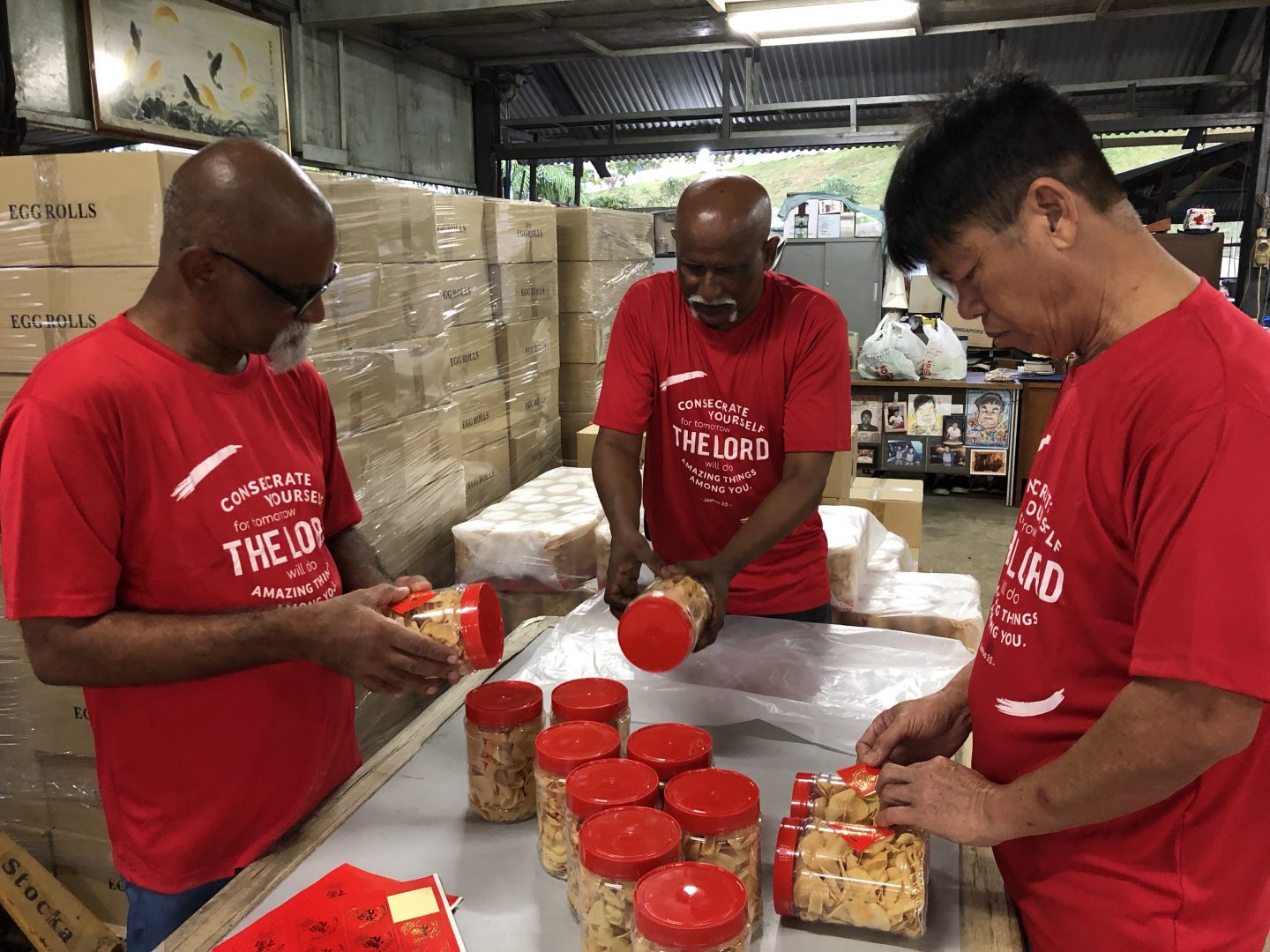 Sart (middle) packing the Chinese New Year goodies with the other THP residents. Photo by Geraldine Tan.