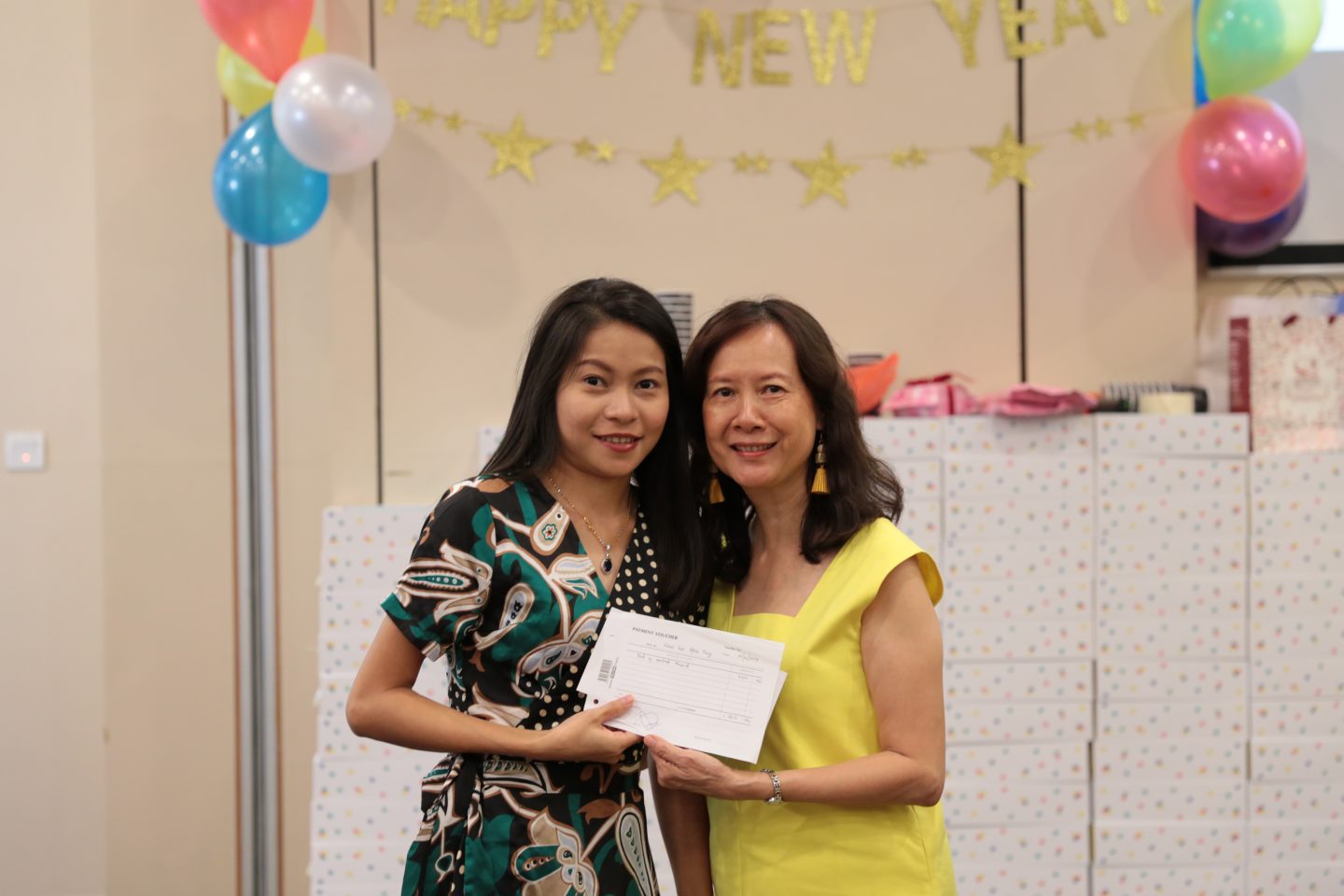 Naw Sar Htoo Ray (left) receiving her end of contract award from Wai Yee (James' wife)