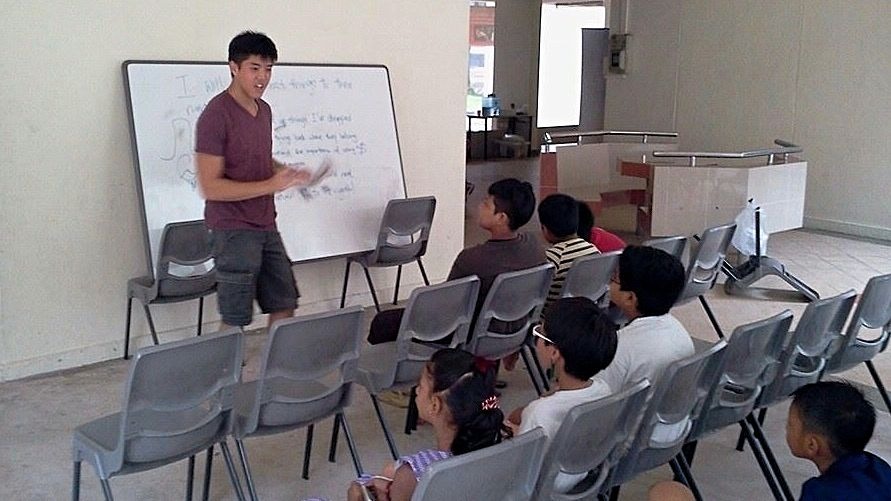 Jonathan teaching the neighbourhood children as part of a church outreach in November 2013.