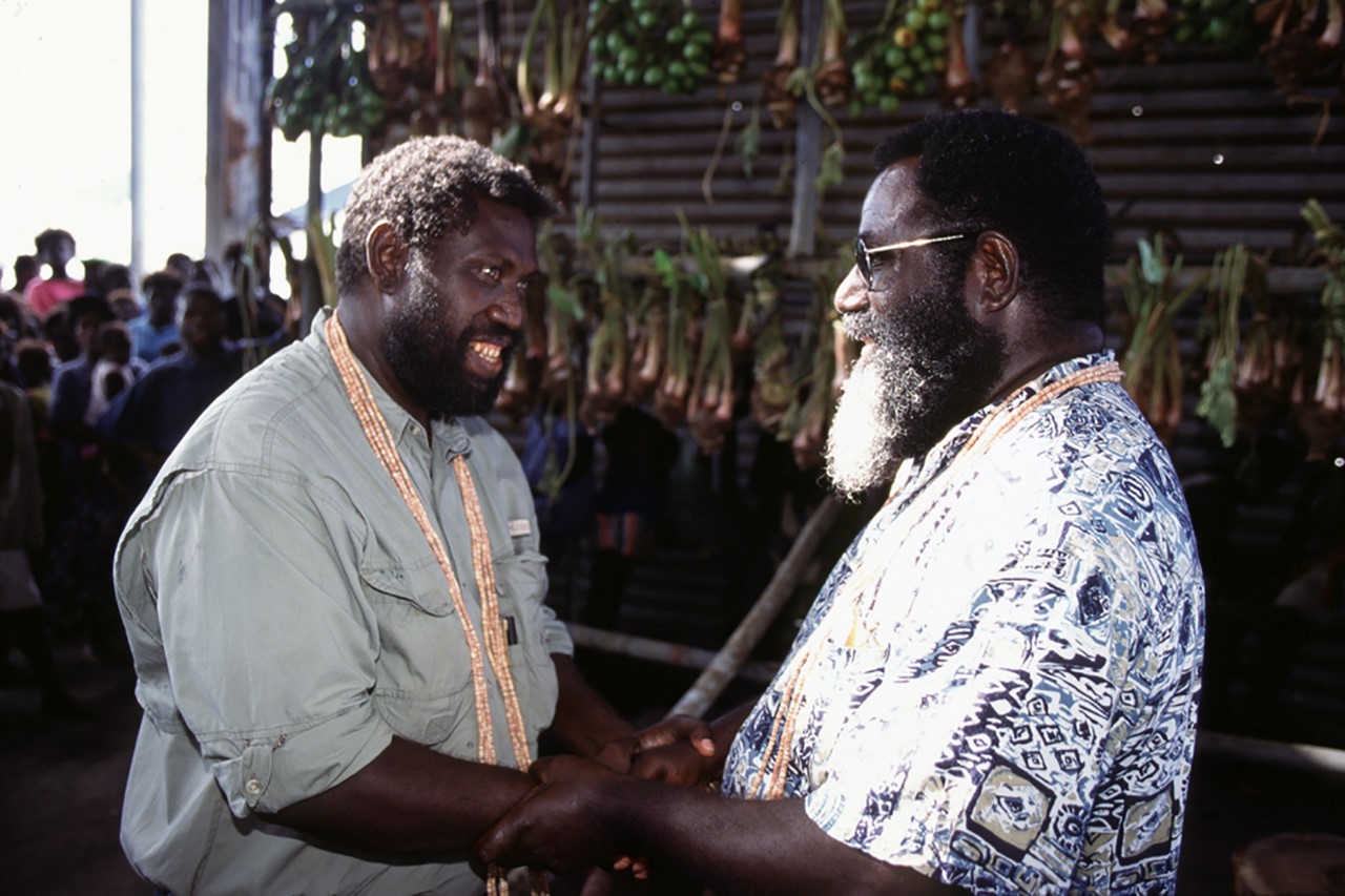 President Joseph Kabui (right) shaking hands with Joseph Watawi as opposing sides reconcile during Doulos' visit to Bougainville (By Tom Brouwer, OM)
