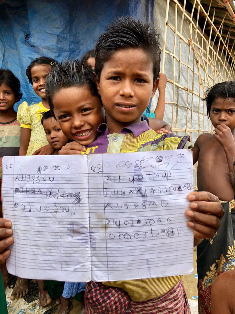 Rohingya children showing what they learned in learning centres set up by aid agencies in Cox's Bazar.
