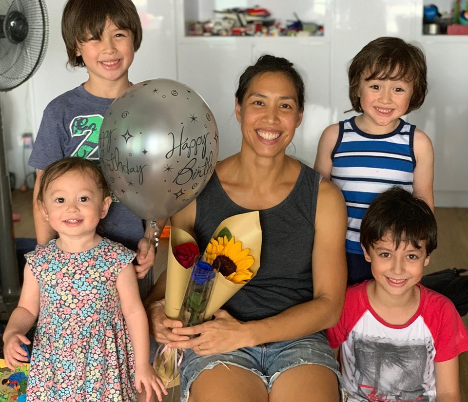 Joscelin Yeo's and her children, each bearing a special 40th birthday gift for their mum. Sarah the youngest, standing in front to the left with Sean directly behind. They both will turn 2 and 8 respectively at year-end. Michael, standing to Joscelin’s right is 4 and David in front, is 6.