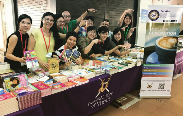The Generations of Virtue team with the expanded book table and publicising the new app PureGen. Photo courtesy of Carol Loi.