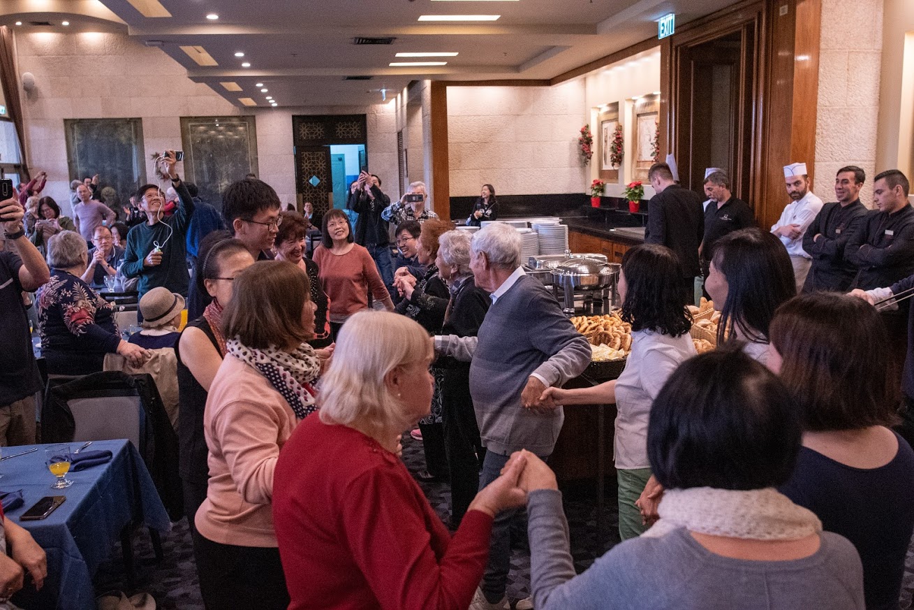 The event, which was held at Olive Tree Hotel in Jerusalem, the Singaporean tourists and Holocaust survivors ate lunch, sang and danced together.