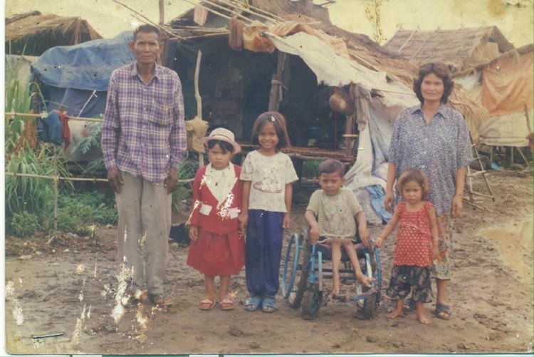 Longdy (second child from right) was the second of six children (two not pictured). After being diagnosed with polio at five years old, he could no longer stand and walk on his own.