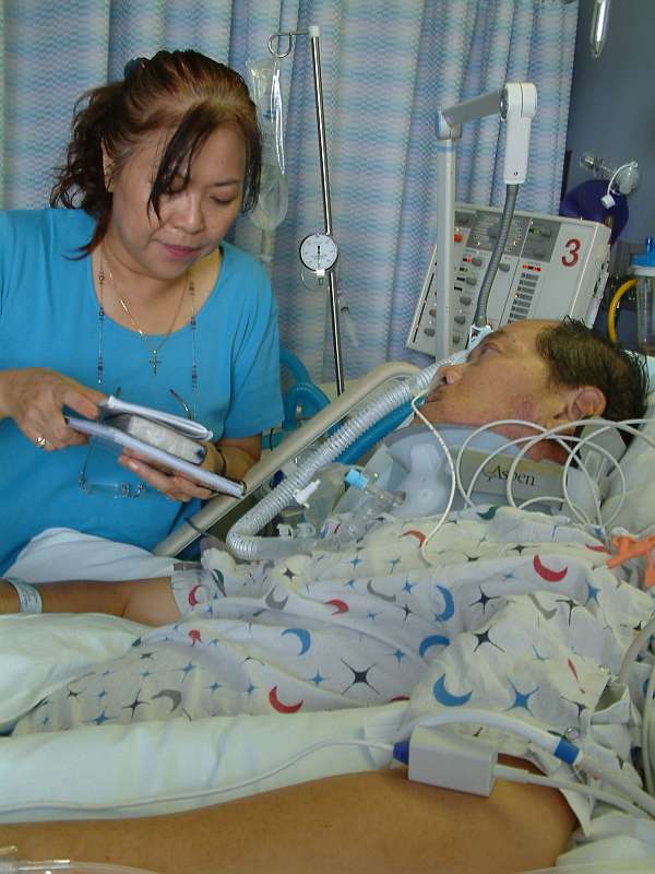 Throughout his stay in hospital, Ps Ling's mother, Margaret, would read the Bible to her husband. Photo courtesy of Ling Kin Yew.