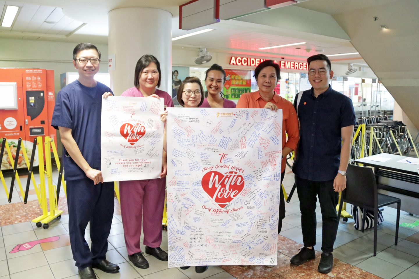 Dr Steven Lim, chief and senior consultant at CGH's A&E (far left) receiving posters of encouragement from Rev Dianna Khoo (second from right). Photo by Netania Pereira.