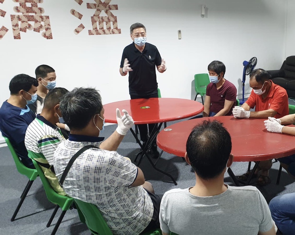 Pastor Cheng Kim Meng from FCBC asking the migrant workers about their working and living conditions, and sharing personal hygiene basics with them.
