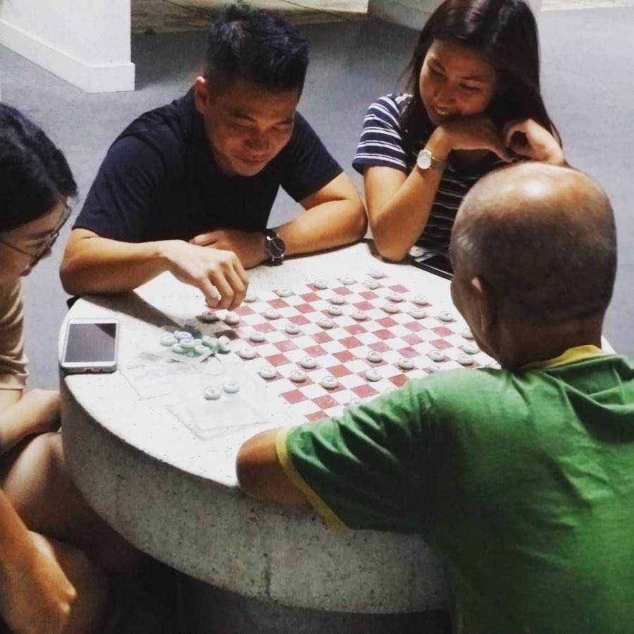HHOS volunteers playing chess with a homeless man during one of their fortnightly outreaches. The organisation seeks, first and foremost, to befriend and love the homeless, instead of just solving their problems. Photo taken from Homeless Hearts of Singapore's Facebook page.