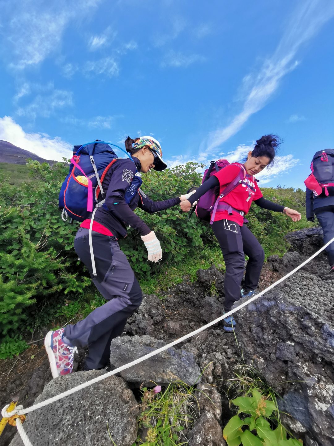 As Denise (right) and Chris (left) ascended Mount Fuji together, Denise described the terrain, trail and scenery.
