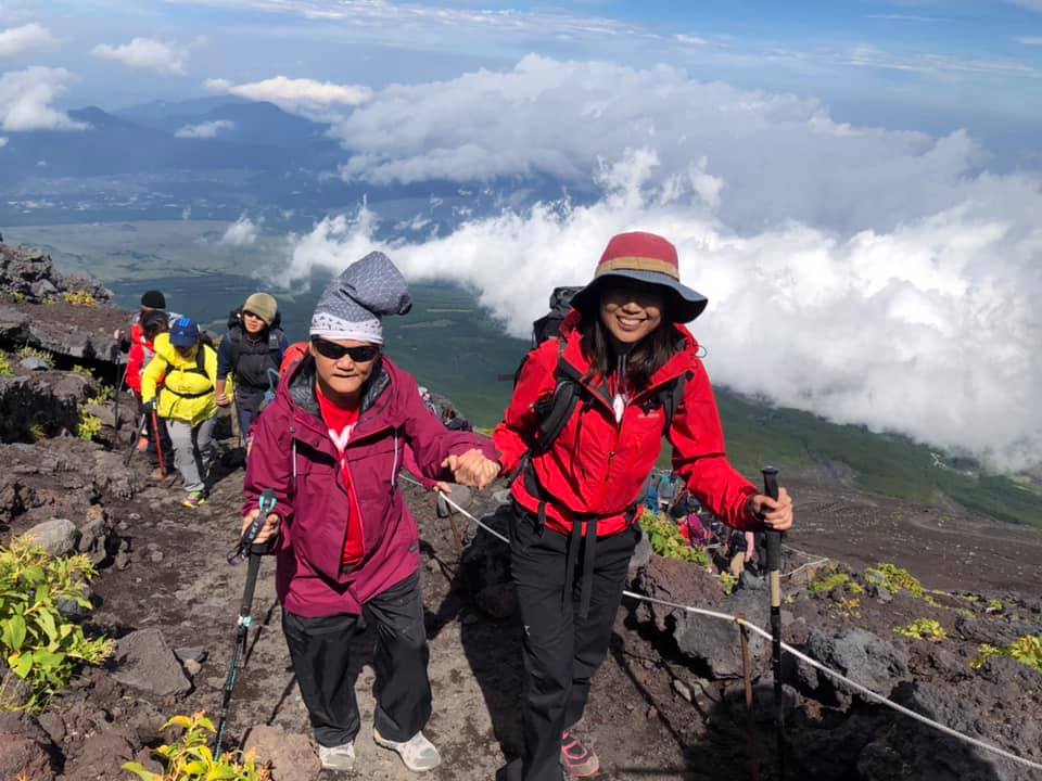 Oh Siew May (left), 49, who has cerebral palsy, joined the climb to prove that "being disabled does not mean unable". Even though she had to crawl at some points, she persevered.
