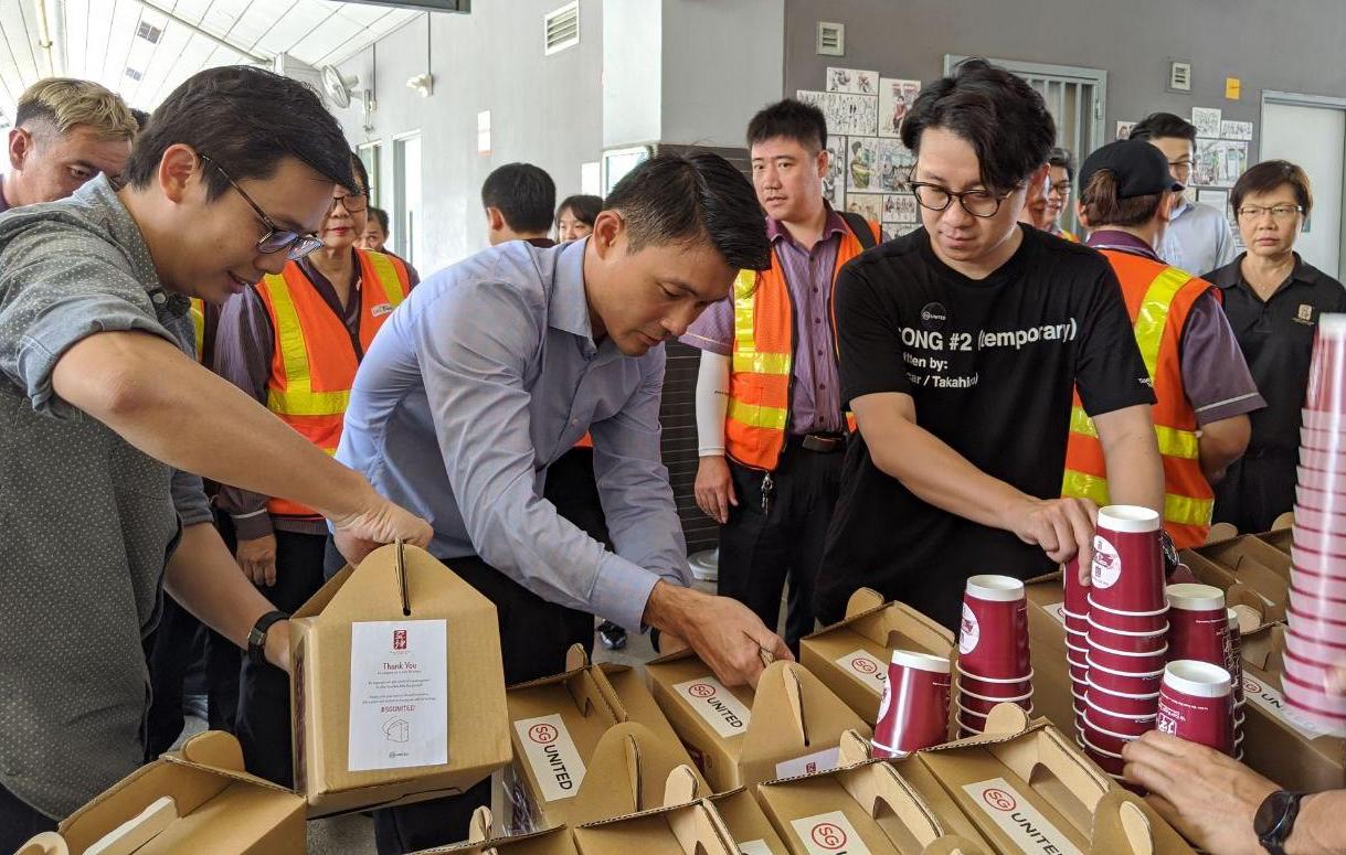 About 50 workers were served free coffee and tea by Jesher Loi (left) director of branding and market development at Ya Kun Kaya Toast, Mr Baey Yam Keng (centre), Senior Parliamentary Secretary, Ministry of Transport and Ministry of Culture, Community and Youth, and Jeff Cheong (right), deputy CEO of DBB Group Singapore. Photo by Gracia Lee.