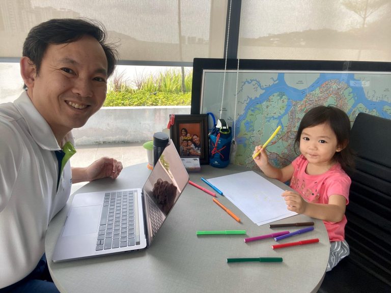 : CEO of Dads for Life and the Centre for Fathering Bryan Tan working from home with his youngest child Deborah during the Circuit Breaker period Photo by Bryan Tan