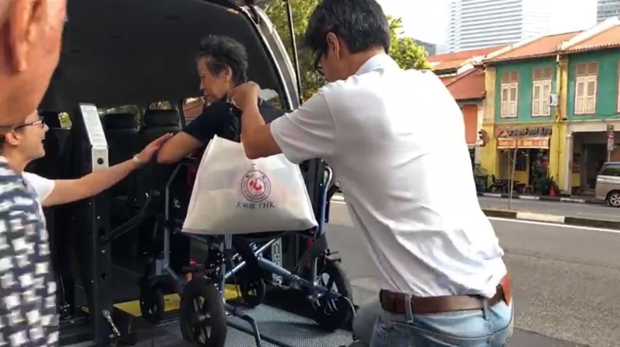 Yeoh and Mei do their best to make sure their clients are comfortable and their wheelchairs secured before setting off. Photo from Go Forth’s Facebook page.