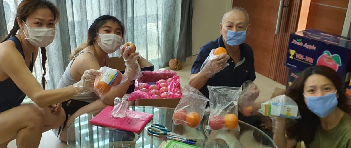 Volunteers helped in ways that they could: One family took this picture as they helped to pack fruits which were funded by another member into individual portions.