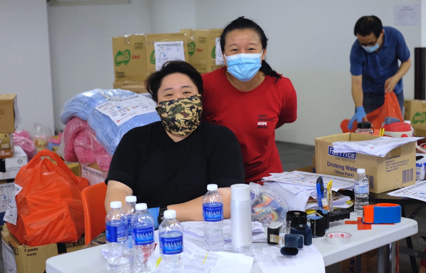 Volunteers Deborah Quek (in red) and Sharon Teo (in black) were helping out at the event since 6am that morning which Quek describes as "fulfilling". Photo by Tan Huey Ying.