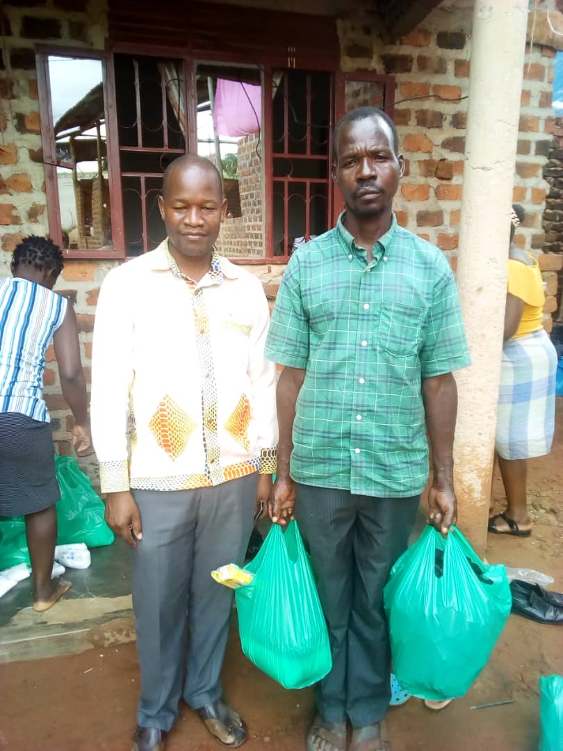 The father (right) with a local leader after chancing upon the church's storehouse and being loaded up with provisions. He had walked fruitlessly for 30km in search of food for his hungry family.