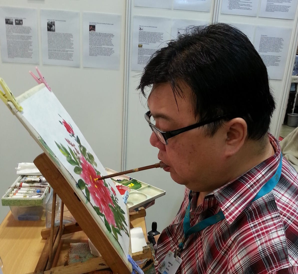 Tan painting at the Singapore Gift Show on July 2014. It looks effortless but mouth painting requires tremendous focus and takes a toll of the gums, mouth, teeth and neck muscles.