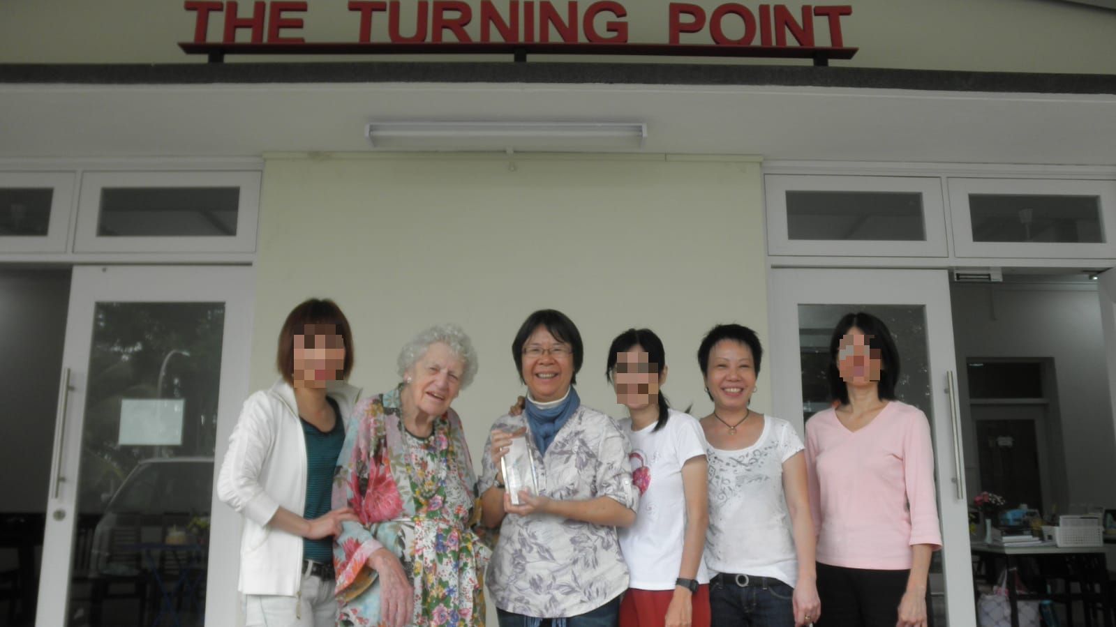 Lim (second from right) experienced God’s love through the people she met at The Turning Point, was transformed and is now giving her life to serving others like her. She is pictured here with founder Florence Ng (fourth from right) and the late Felicity Foster-Carter, who was the first DRC volunteer of the Prisons Department. Faces have been blurred to protect their identities. Photo courtesy of Florence Ng.