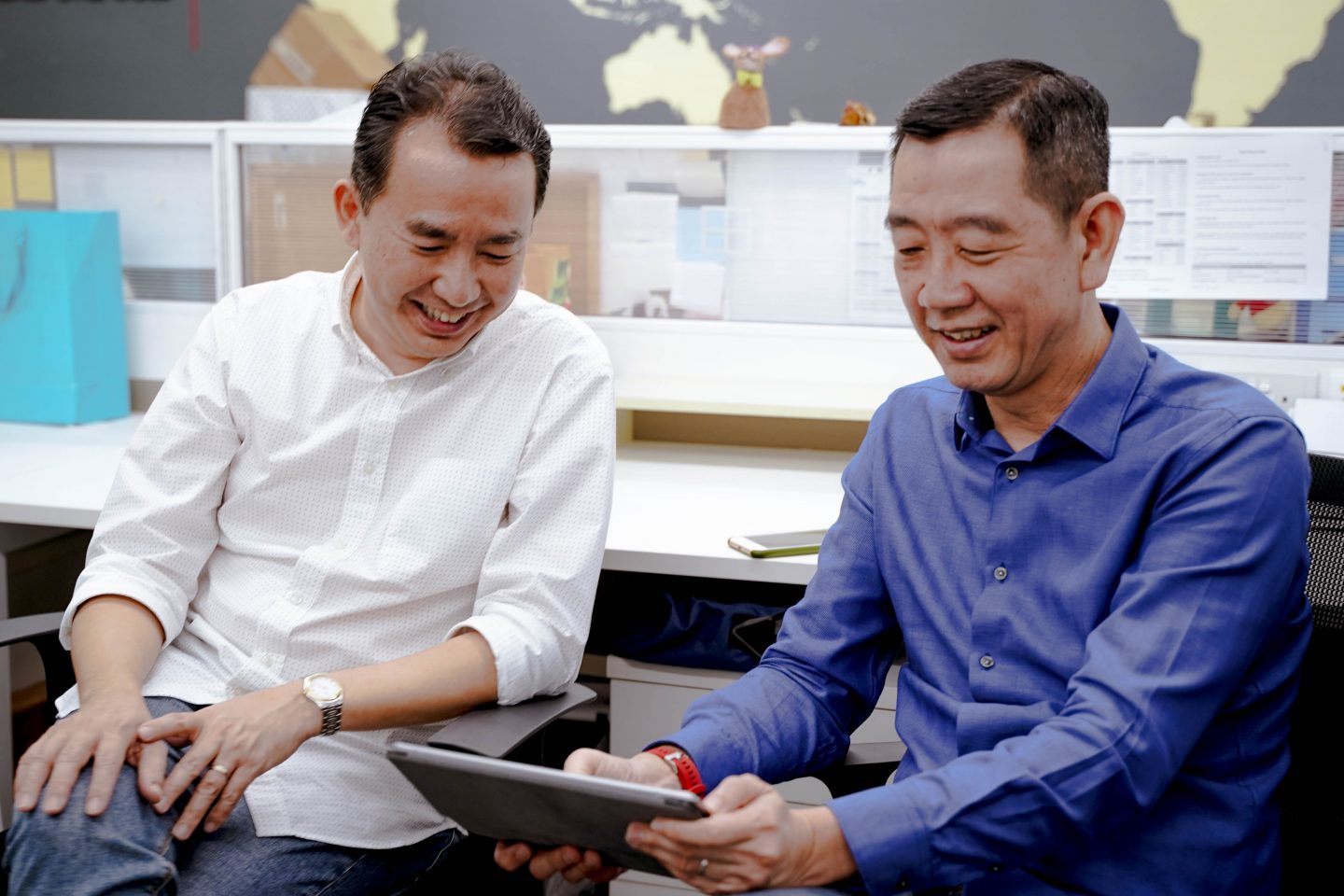 Hock Chye and Kok Hiang sharing a jovial moment in office.