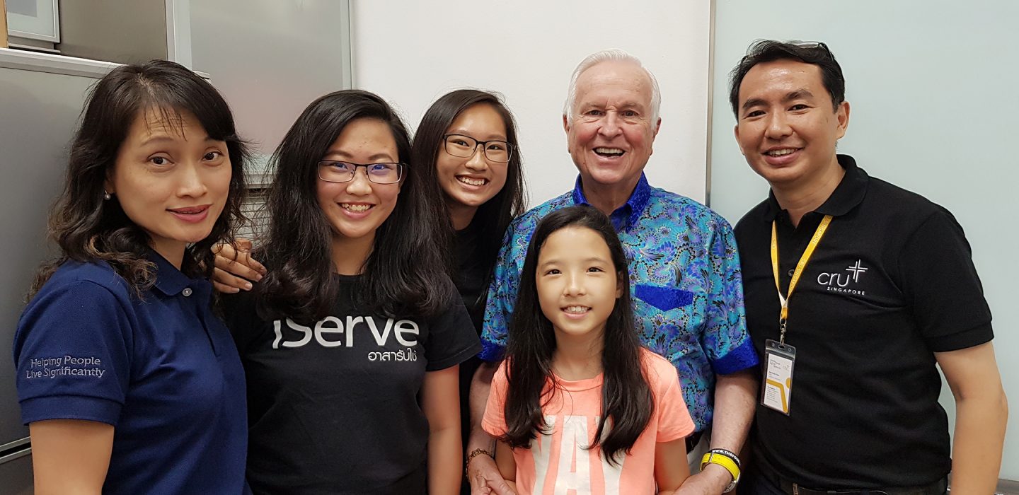 Hock Chye with his wife and three daughters, alongside speaker Josh McDowell