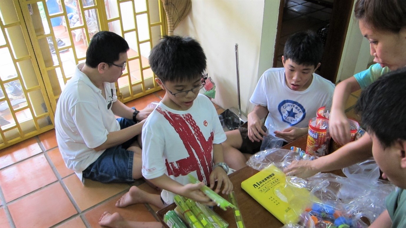 Ethan (centre) on a mission trip to Cambodia when he was still in Primary School. The early exposure to missions helped him discover his personal calling in missions. Photo courtesy of the Tan family.