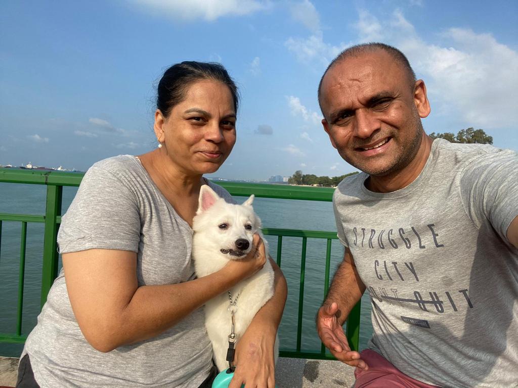 Gita and Anil now share a closer bond after both came to know Christ. They are pictured here with their family dog.