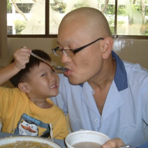 Young Joshua feeding his father in hospital.