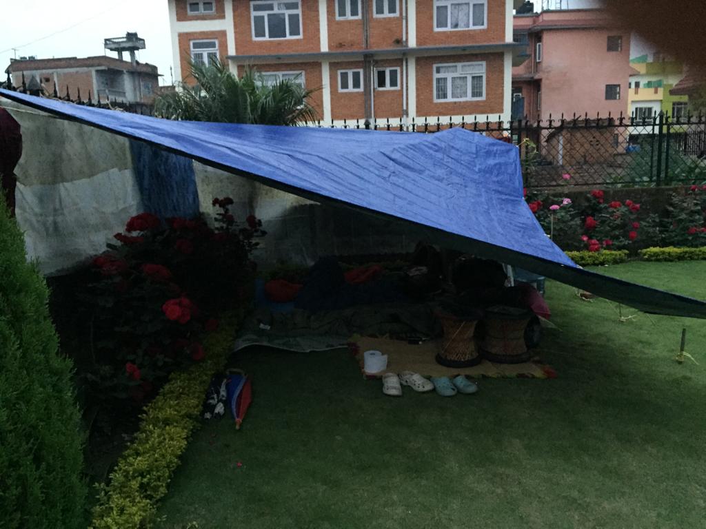 The family stayed in a makeshift tent outside their house during the earthquake. 