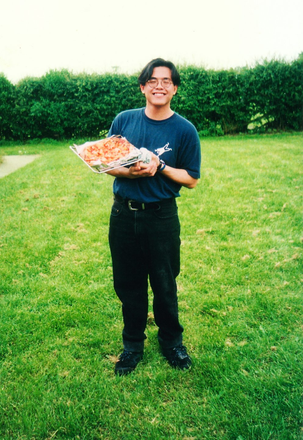 Christopher Tan, during his university days, making pizza for everyone while on a weekend away with the Christian Union folks.