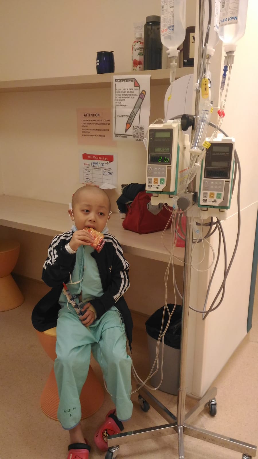 Raphael eating a snack while attached to his IV line. 