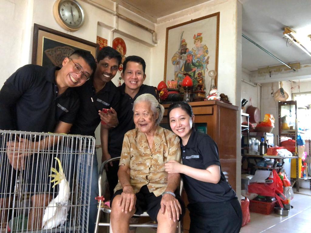Staff from his company volunteering with elderly beneficiaries under MYMCA. 
