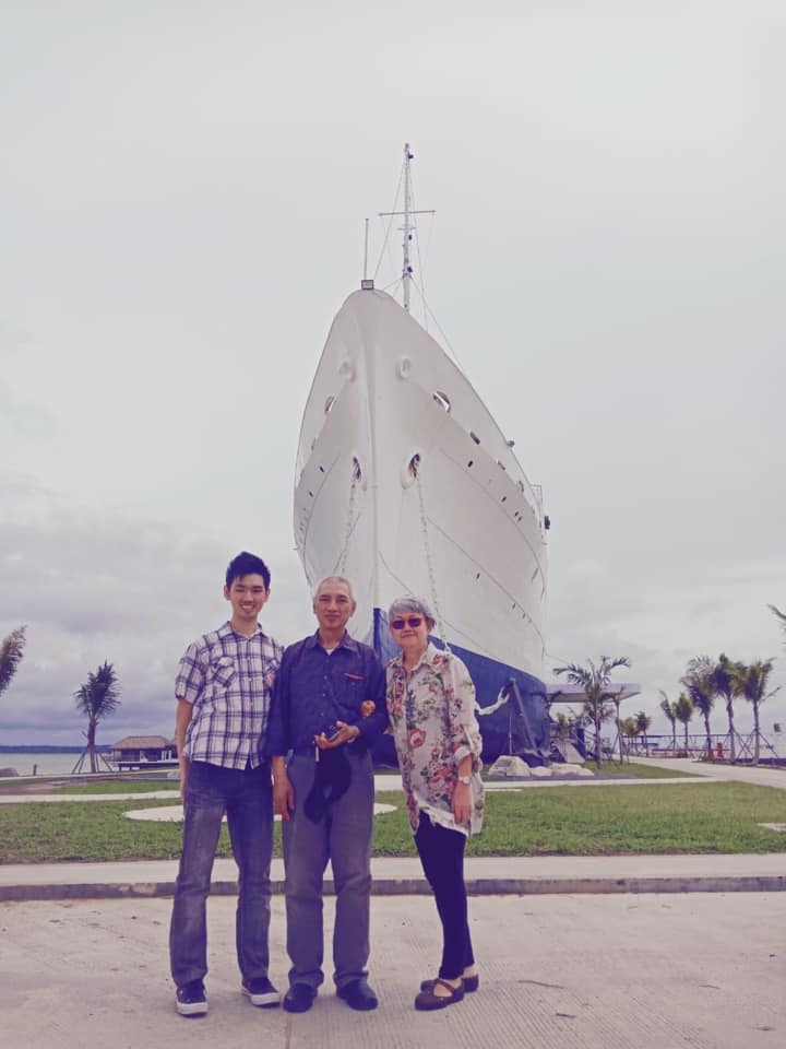 Ngoh with his wife and family when they visited MV Doulos (in background), which now serves as a hotel in Bintan. Photo courtesy of Ngoh Tee Peng.