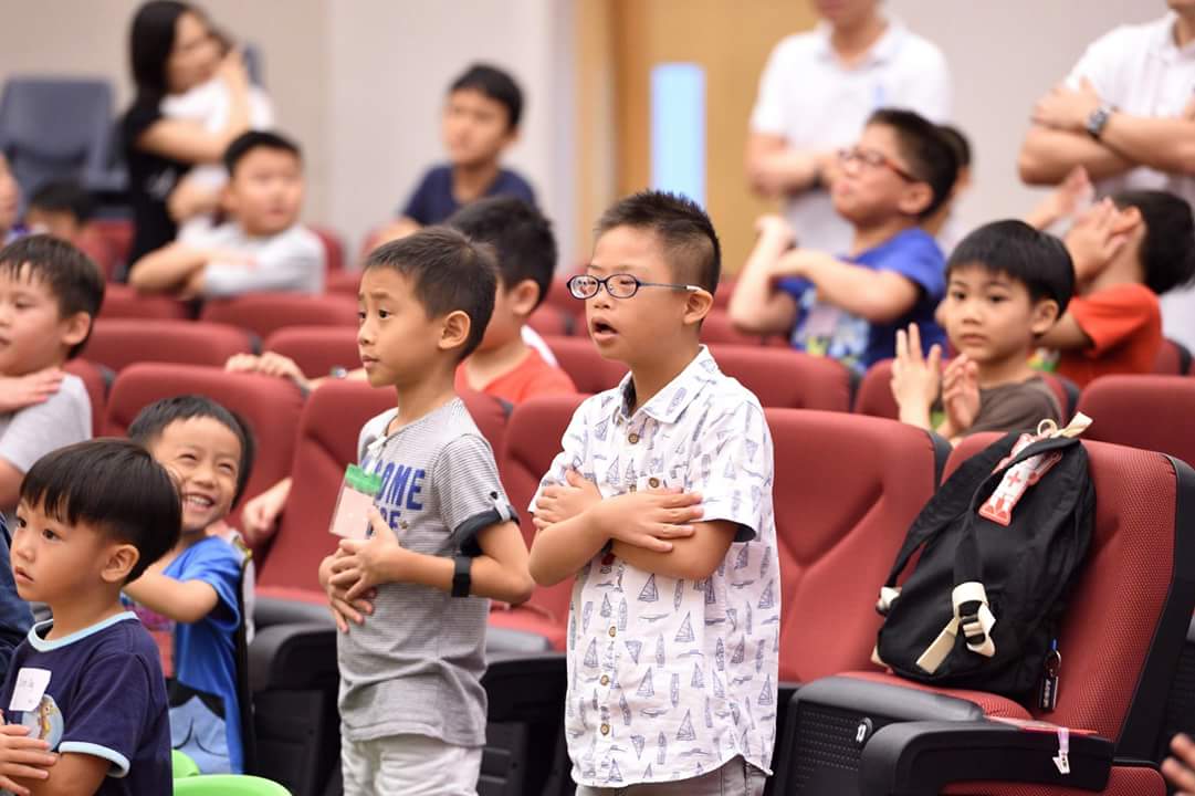 Sherlyn Quek's second child, Elliot (in white), 14, who has Down Syndrome, worshipping in church. Her dream is to see him serving actively in church. Photo courtesy of Sherlyn Quek.