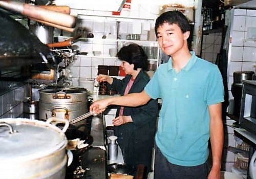 Sih in his early 20s with his mother. He helped out at his family's Indonesian restaurant in Amsterdam since he was 12.