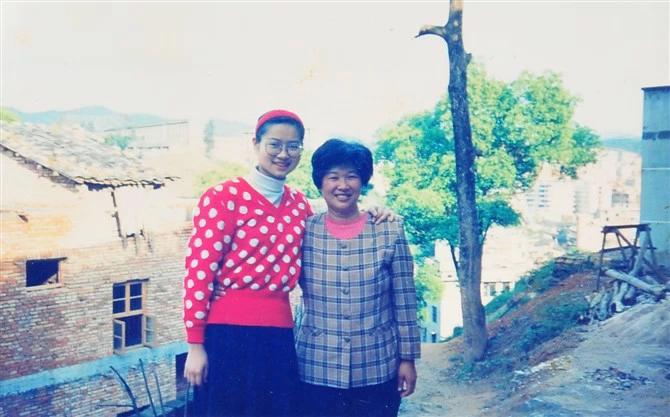18 year old Wu Xia in a red polkadot sweater, next to her mother
