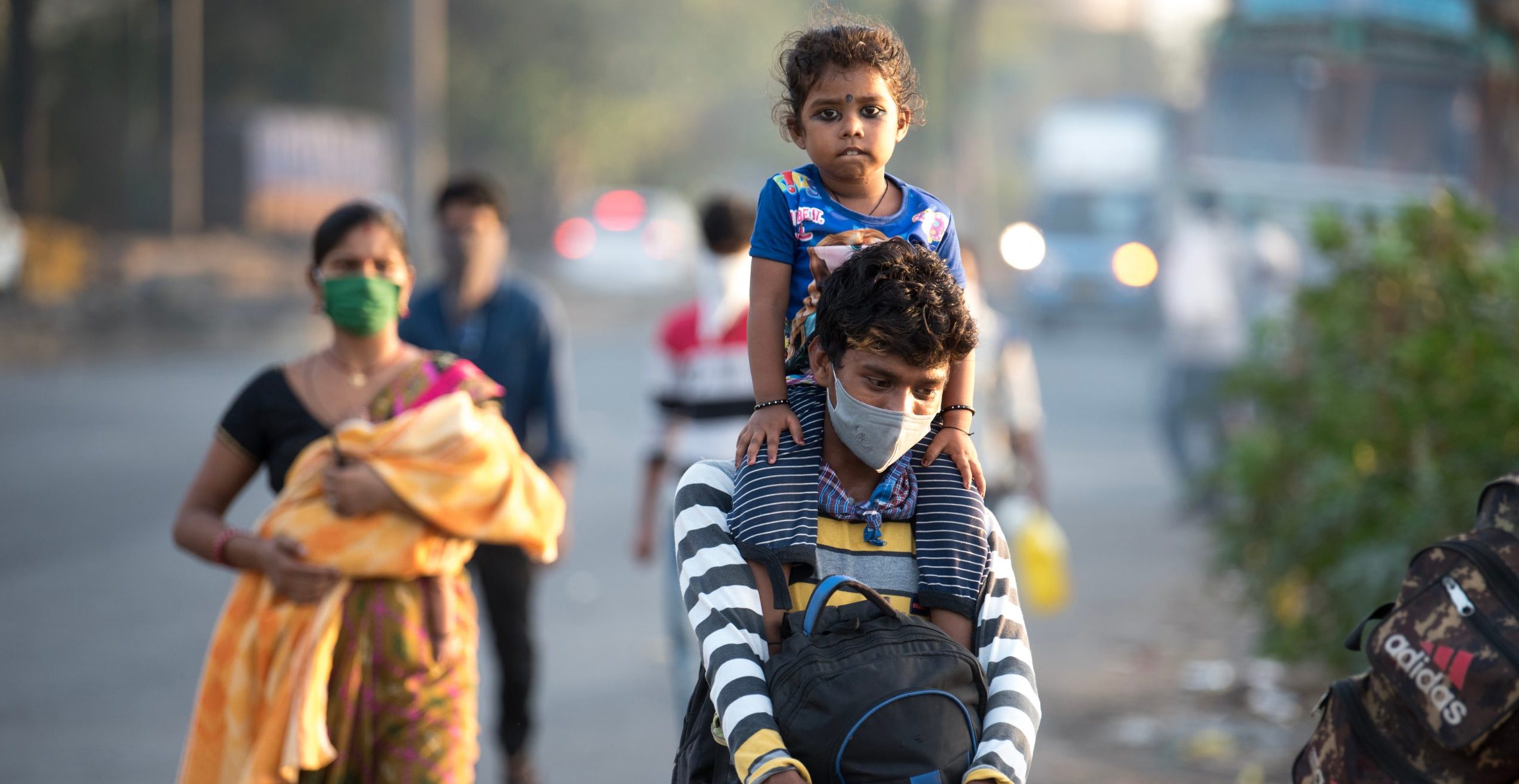 Migrant workers in Mumbai walk on the highway as they journey back home during a nationwide lockdown in May 2020. Photo by Manoej Paateel/ Shutterstock.com.