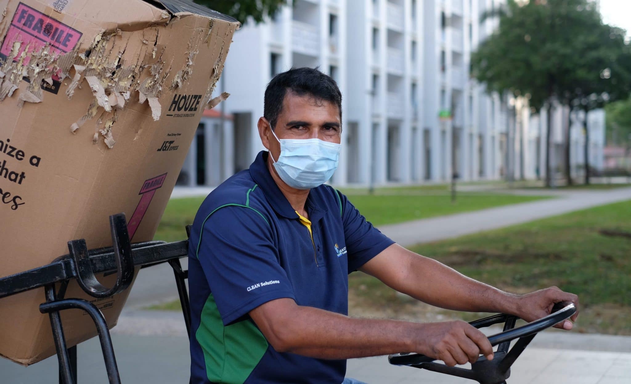 For 12 hours every day, Forhad Ali makes his way around a 16-block estate sweeping floors, clearing bulky items and responding to residents' requests for help. All photos by Tan Huey Ying.
