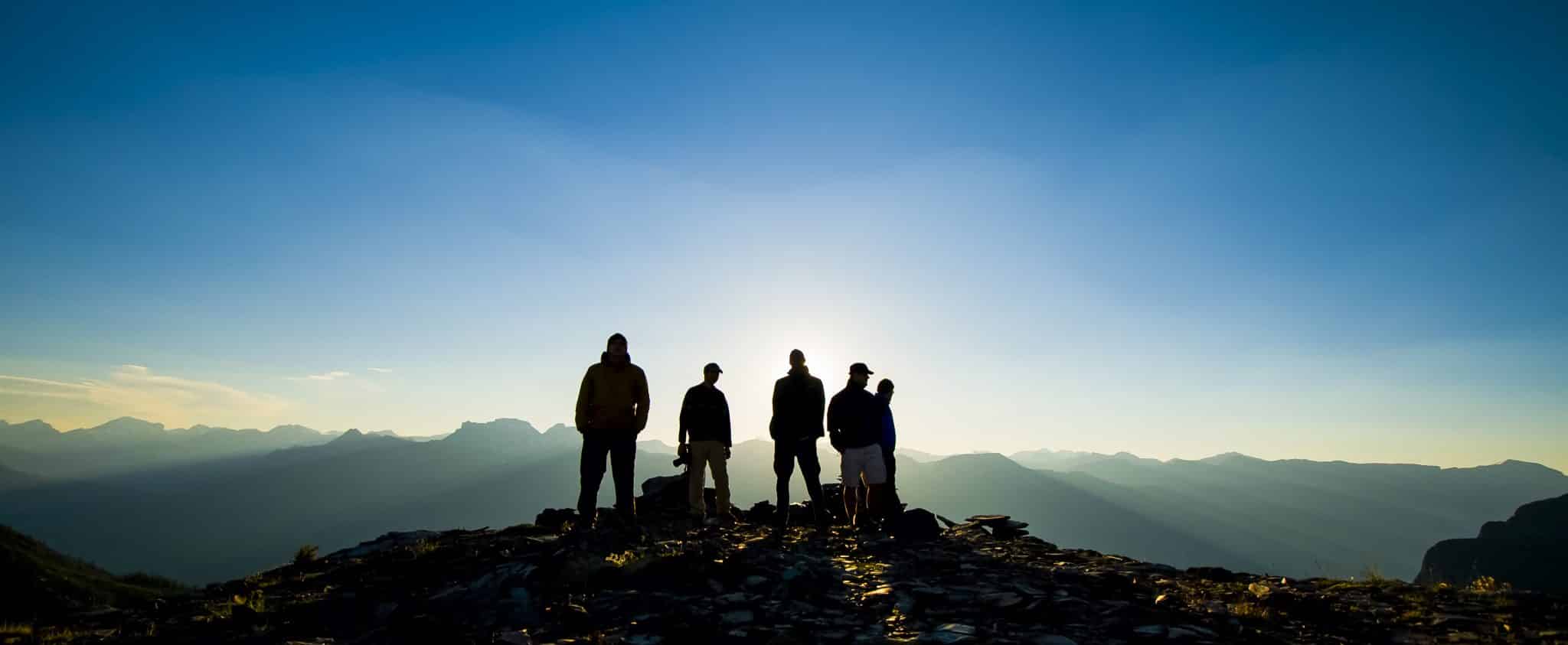 Silhouettes on Mountain at Sunrise