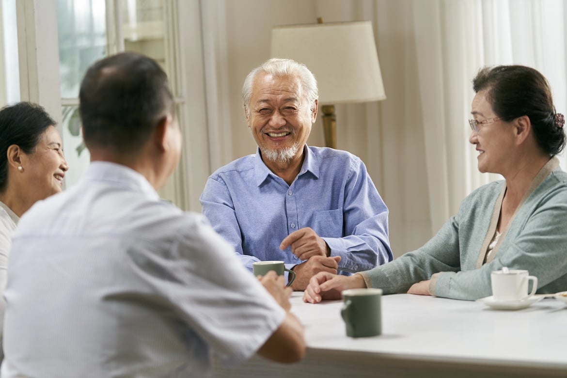 happy senior asian people gathering and chatting at home