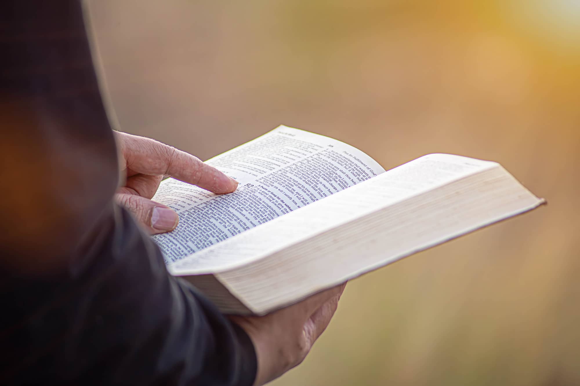 young man pointing to a bible topic and read the Bible on Sunday