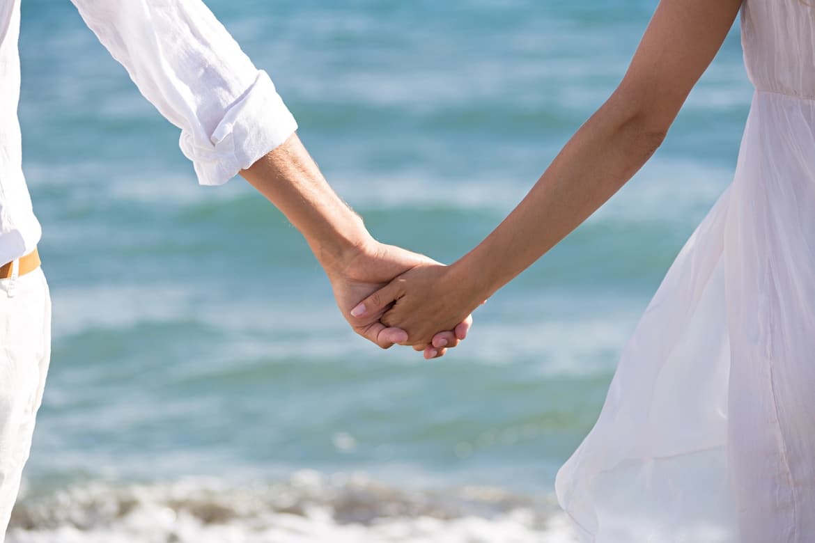 happy couple in love walking on the beach