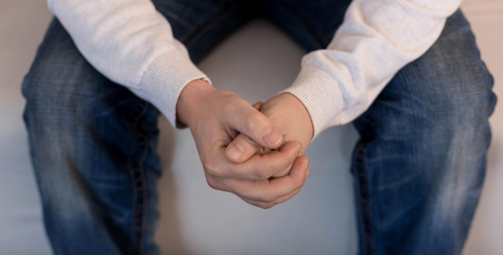 Male hands clasping worries