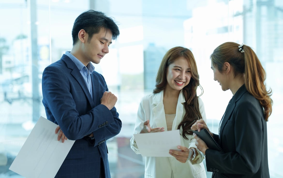 Entrepreneur asian business people discussing new business project in paper sheet in modern meeting room.